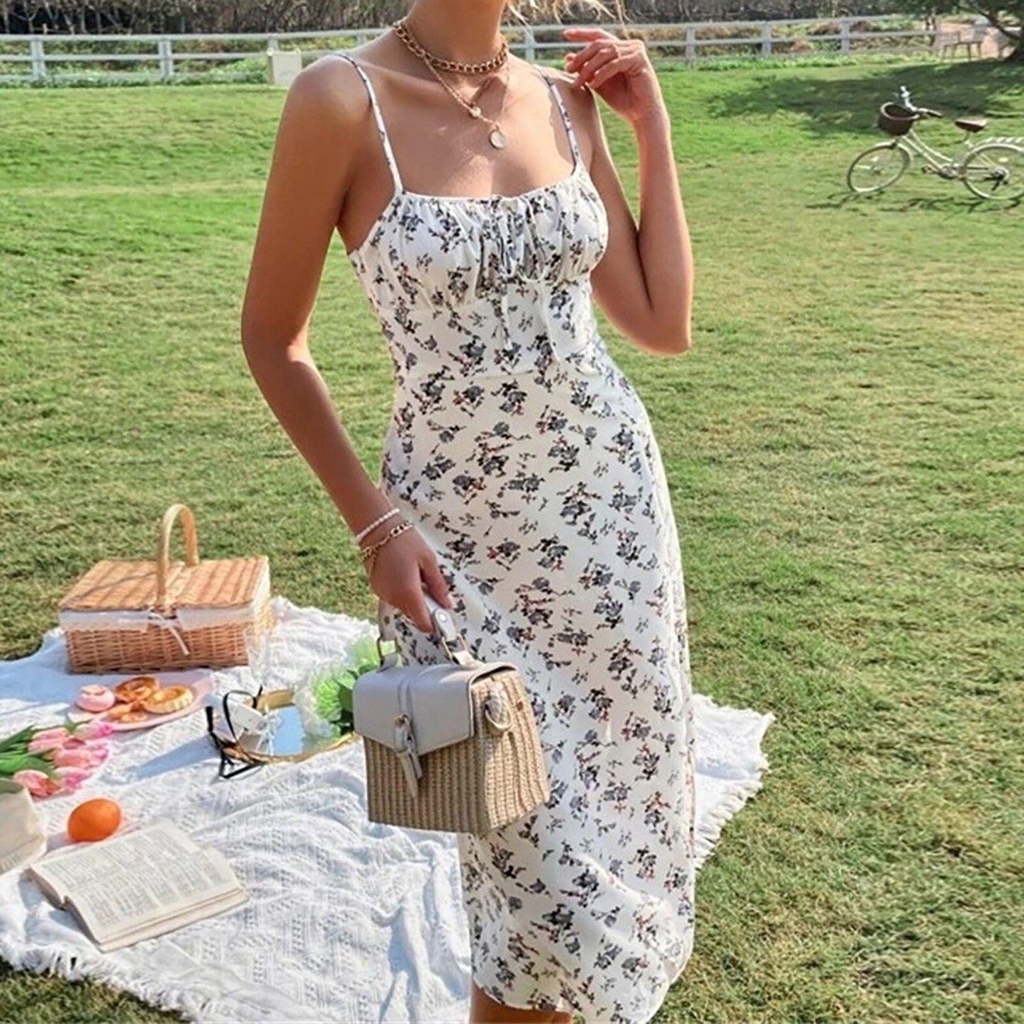 Woman wearing a white floral print midi dress in a park setting