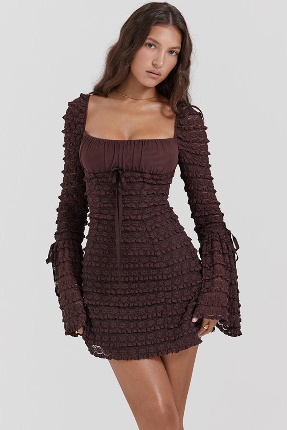 Woman wearing a short, brown, long-sleeved ruched dress with a square neckline and bell sleeves.