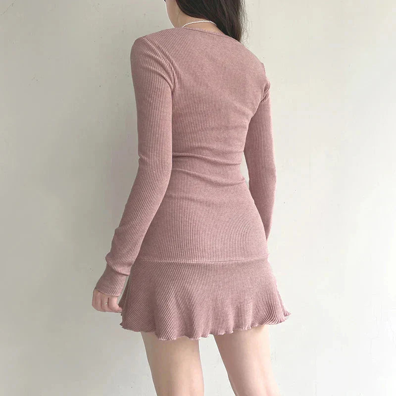 back view of a woman wearing a pink ribbed knit dress