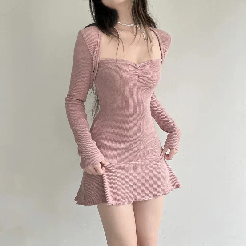 woman posing in a pink ribbed knit dress