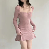 woman posing in a pink ribbed knit dress