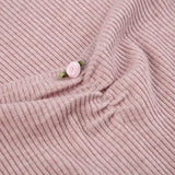 close-up of the ruching and detail on a pink ribbed knit dress