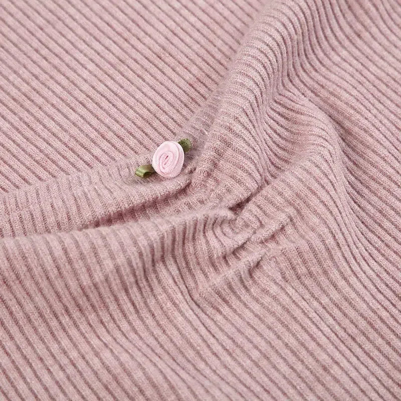 close-up of the ruching and detail on a pink ribbed knit dress