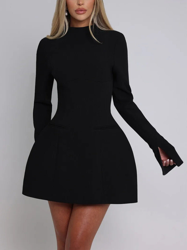 Front view of a woman wearing a black long-sleeved dress with a high neckline, flared skirt, and pocket details