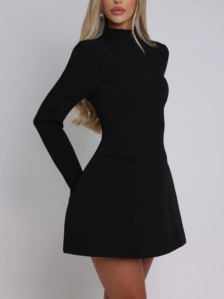 Side view of a woman wearing a black long-sleeved dress with a high neckline and flared skirt