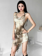 A woman poses in a beige and brown tie-dye mini dress with a hooded cowl neck and distressed detailing.