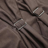 Close-up of the ruched fabric and buckle details on a brown dress.