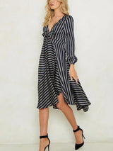Side view of a woman in a striped dress, highlighting the flowy skirt