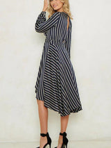 Rear view of a woman in a striped dress, showing the open back detail