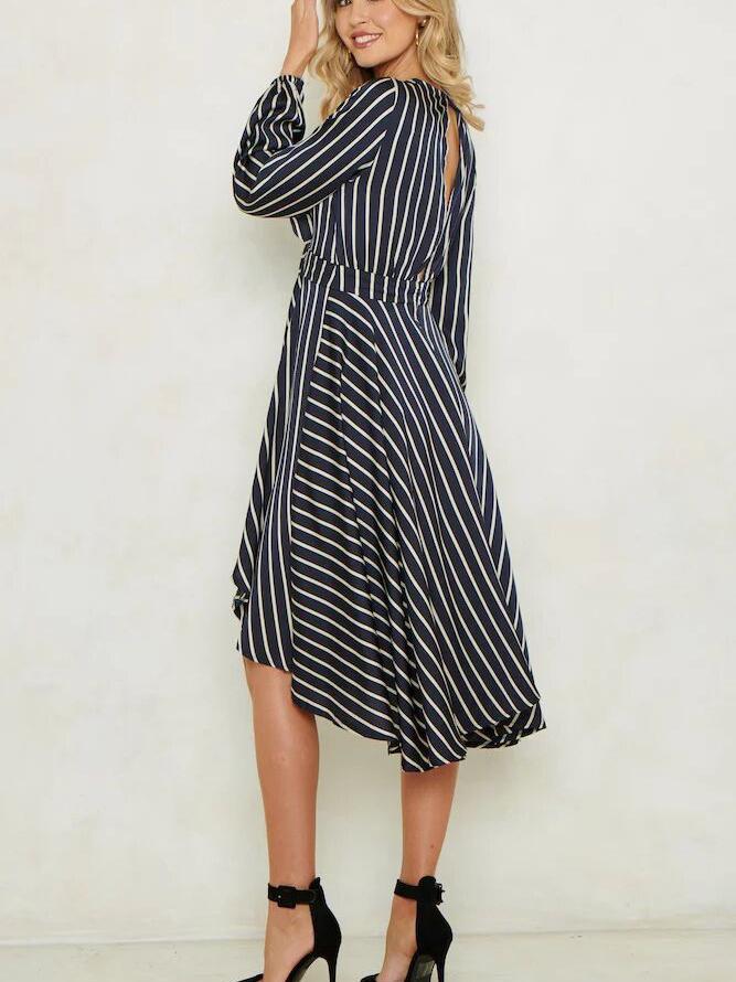 Rear view of a woman in a striped dress, showing the open back detail