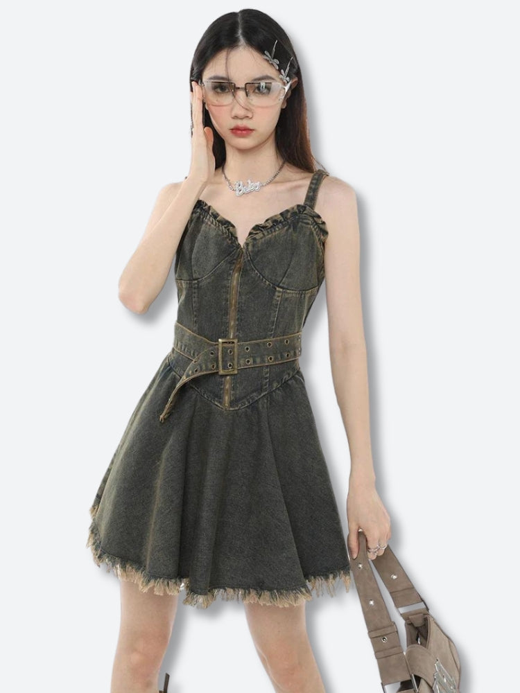 Front view of a black denim dress with a zipper and ruffled neckline