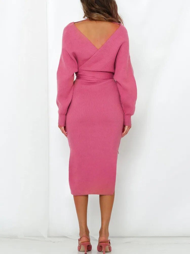 back view of a woman in a pink knitted wrap dress