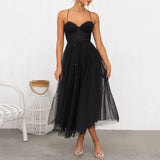 woman in a black midi tulle dress with spaghetti straps and a sweetheart neckline
