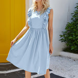 woman in light blue ruffled dress twirling