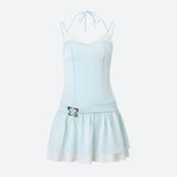 Product image of a light blue and white ruffled dress with a butterfly embellishment and spaghetti straps.