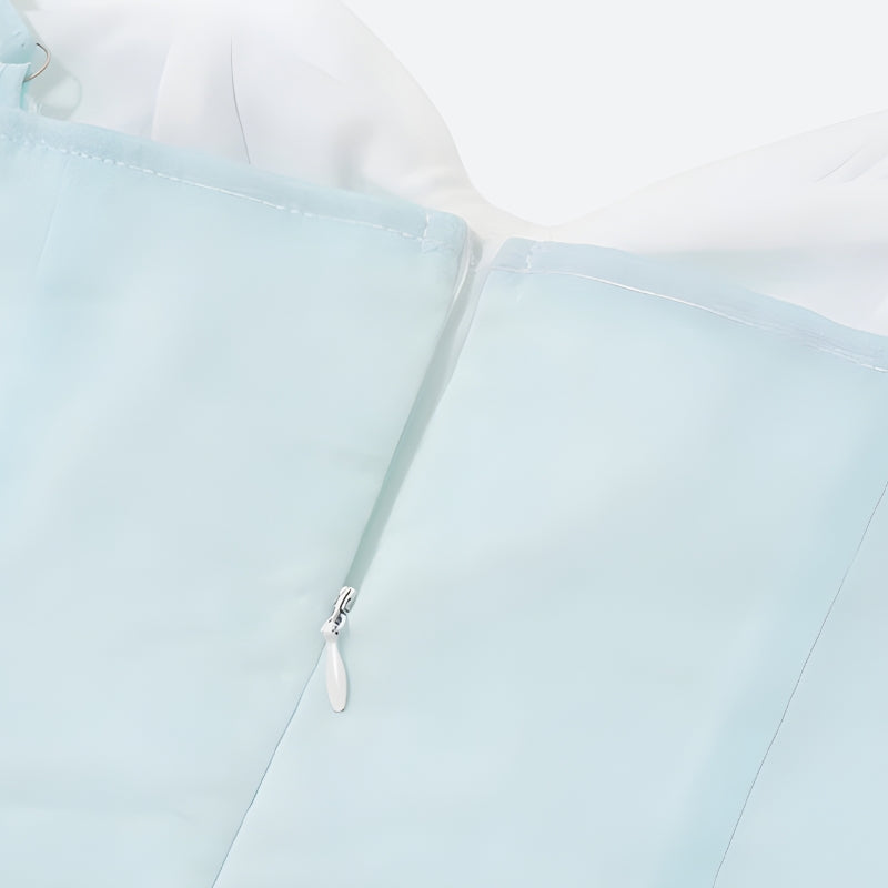 Close-up of the zipper on a light blue dress.