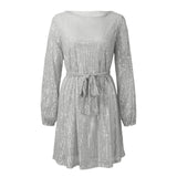 A silver sequined dress with long sleeves and a belted waist, shown flat.