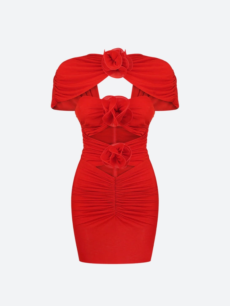 A red ruched mini dress with cut-out details and floral embellishments, shown flat.