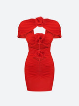 A red ruched mini dress with cut-out details and floral embellishments, shown flat.
