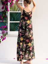 Back view of a woman in a black floral maxi dress.