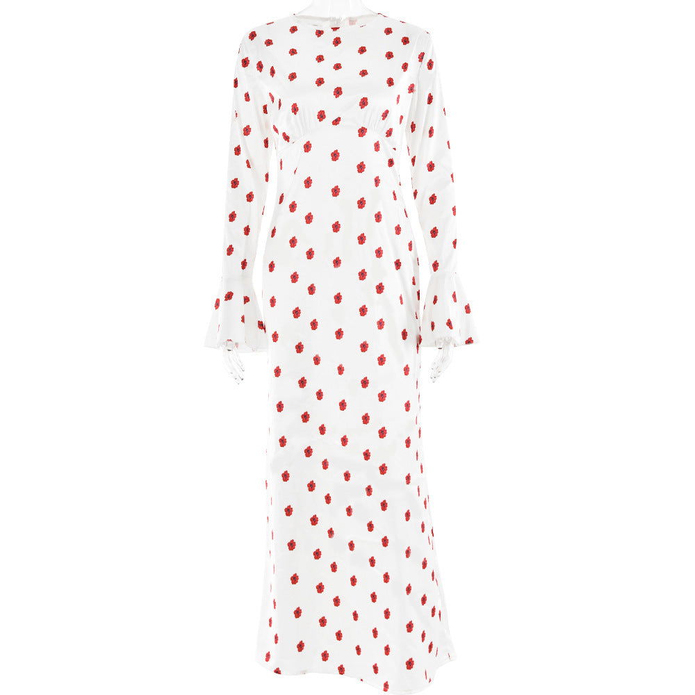 White polka dot maxi dress with red polka dots and long bell sleeves.