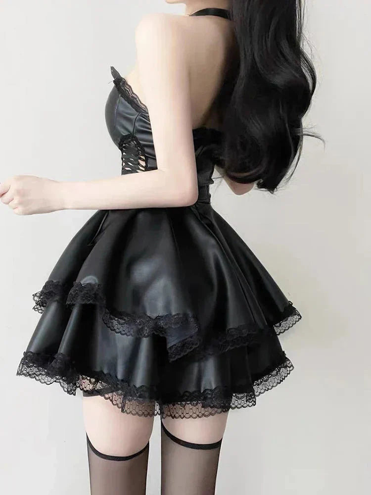 Back view of a woman in a black strapless leather-like dress with lace trim.
