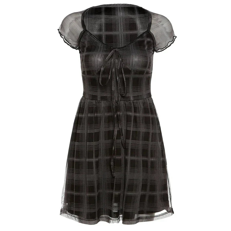 A black and gray plaid dress with sheer sleeves and a tie-front closure, displayed on a white background.