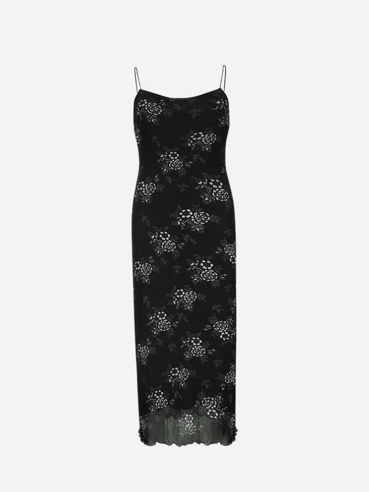 A black slip dress with a white floral pattern and a sheer, ruffled hem.