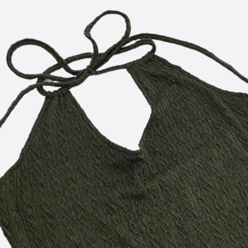 Close-up of the halter neck and keyhole cutout of an olive green dress