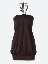 A brown halter dress with ruching and a bubble hem.