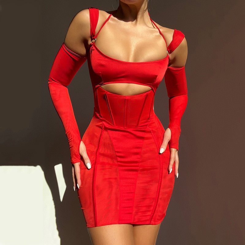 A woman wearing a tight, short red dress with a cutout at the bust and long, detached sleeves. The dress has a corset-like bodice and thin straps.