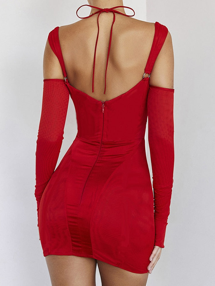 Back view of a woman in a red dress with a low back and a zipper closure. The dress has thin straps and detached long sleeves.