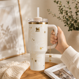 Stanley Celestial Star 40oz insulated tumbler in soft cream with gold starburst pattern and hanging star charm - View 3 | Clistos