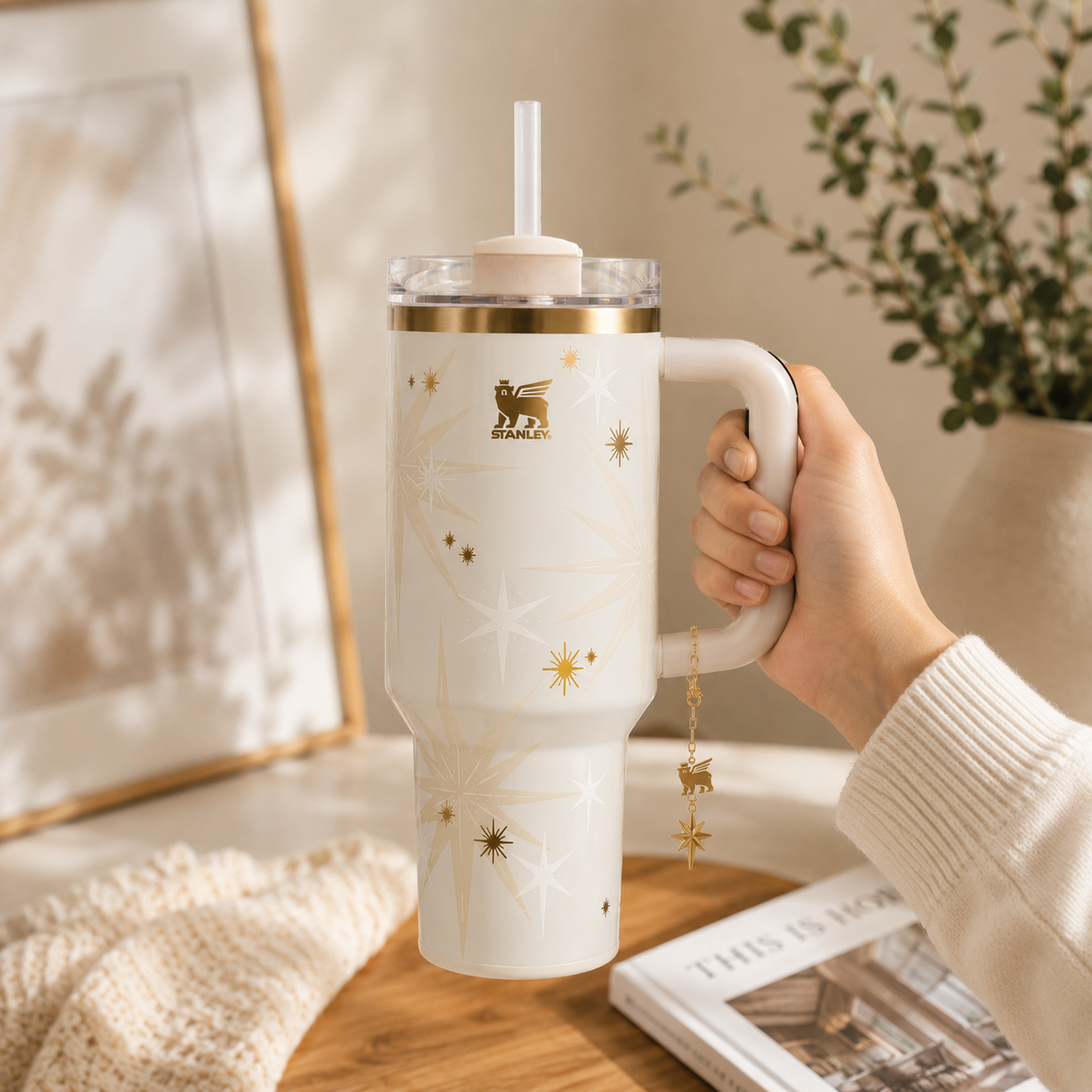 Stanley Celestial Star 40oz insulated tumbler in soft cream with gold starburst pattern and hanging star charm - View 3 | Clistos
