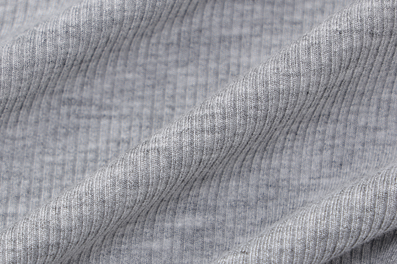 Close-up of the ribbed texture of a grey fabric