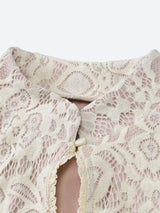 close-up of the neckline of a white lace dress