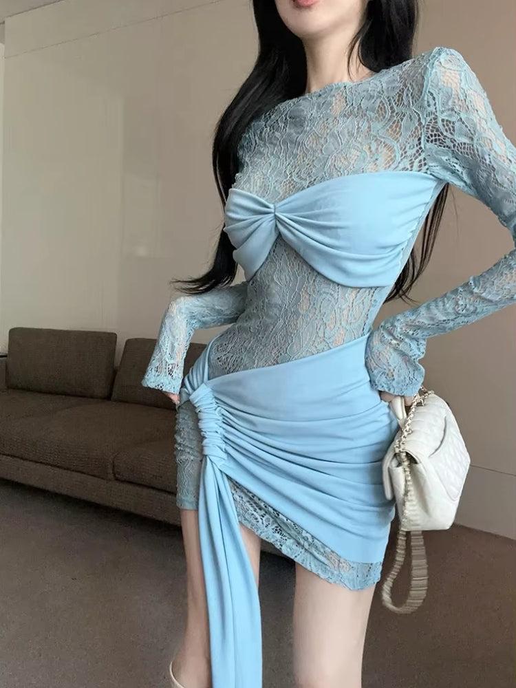 Close-up of a woman wearing a light blue lace dress with a ruched skirt and a bow detail on the bust.