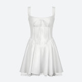 A white mini dress with spaghetti straps, a sweetheart neckline, a corset bodice, a pleated skirt, and lace trim.