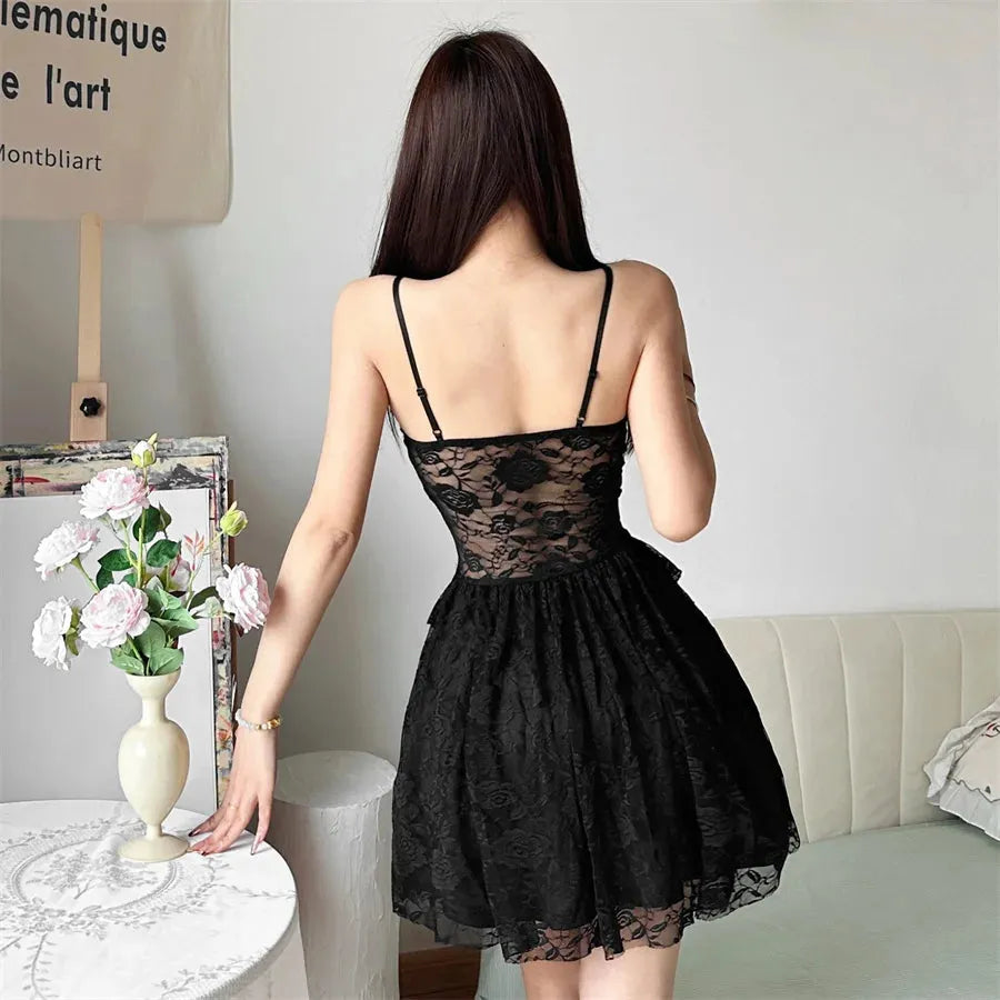 Woman wearing a black lace slip dress, back view