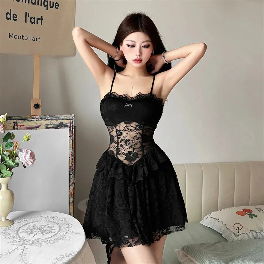 Woman wearing a black lace slip dress, hands on head