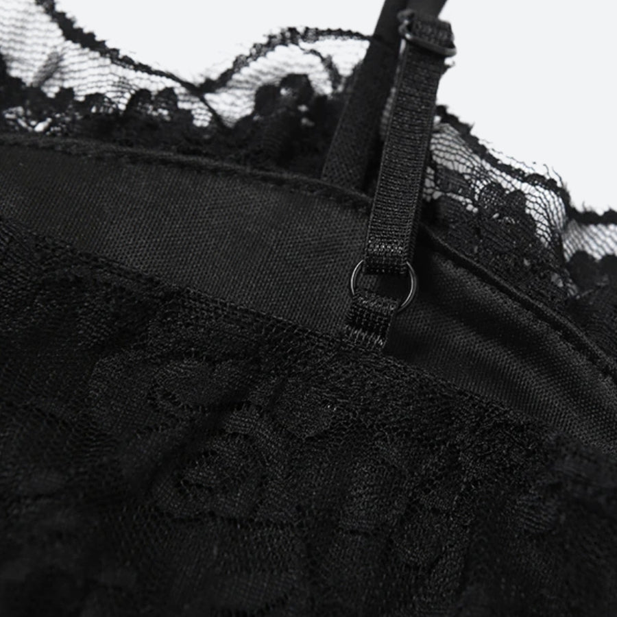 Close-up of the spaghetti strap and lace detail on a black slip dress