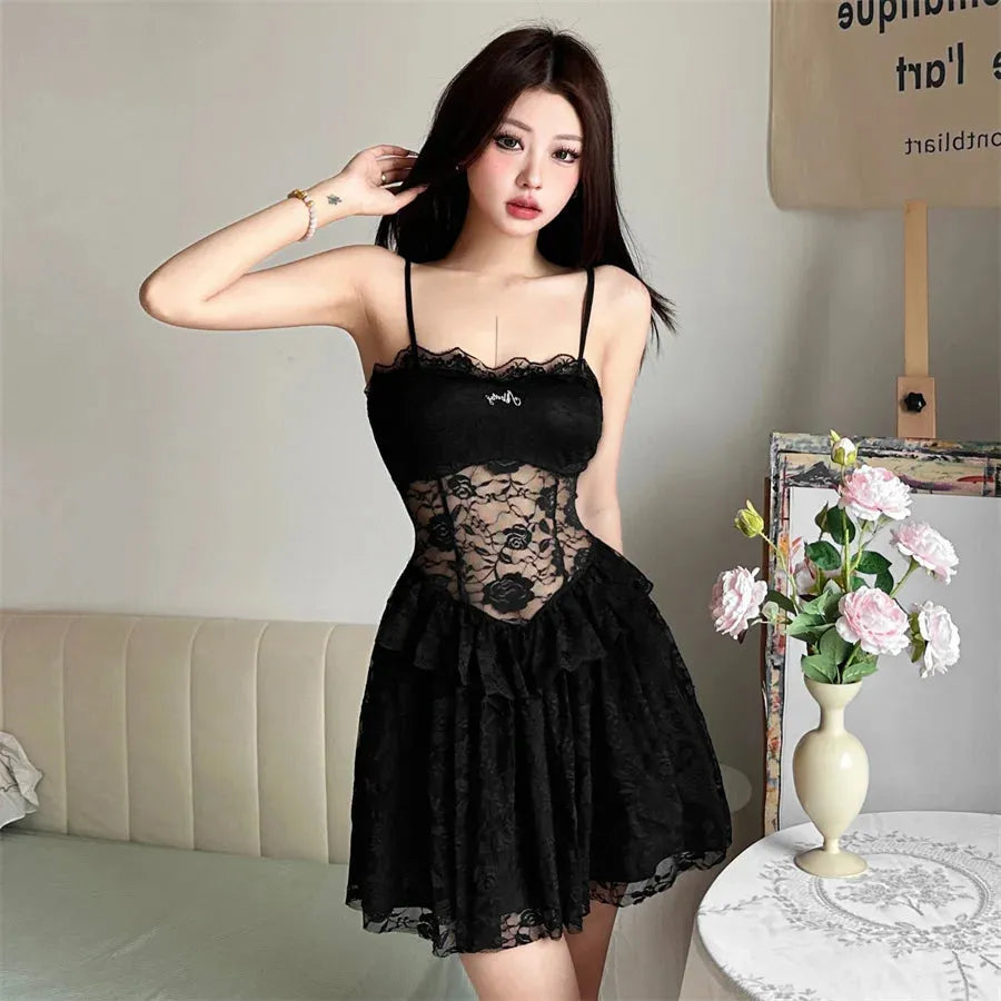 Woman wearing a black lace slip dress, front view
