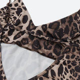 Close-up of the open back detail of a leopard print slip dress.
