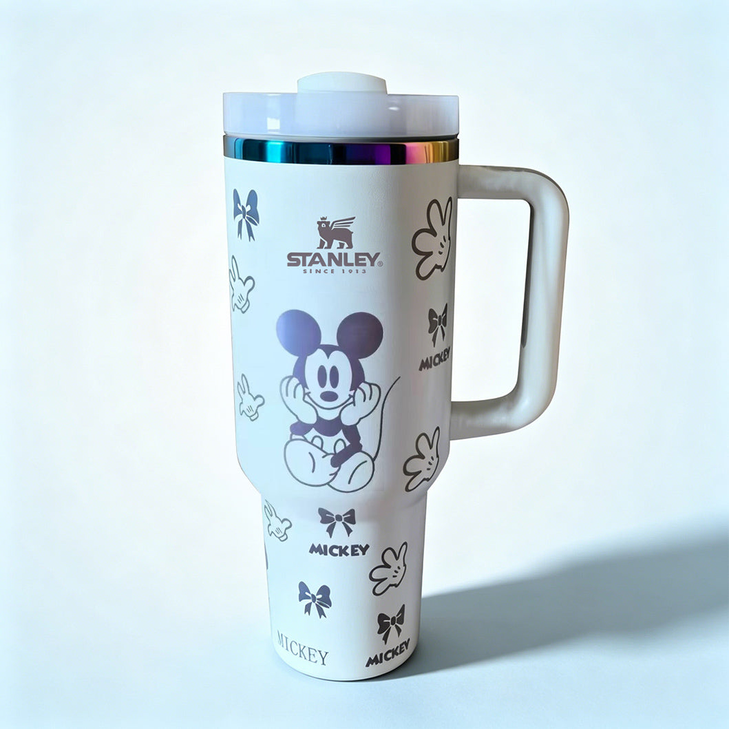Stanley 40 oz Mickey Mouse insulated tumbler in white with classic Mickey character drawings, gloves, bows, and ergonomic handle - View 1 | Clistos