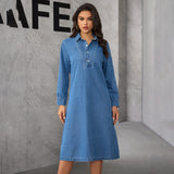 Full shot of a woman in a blue denim dress.