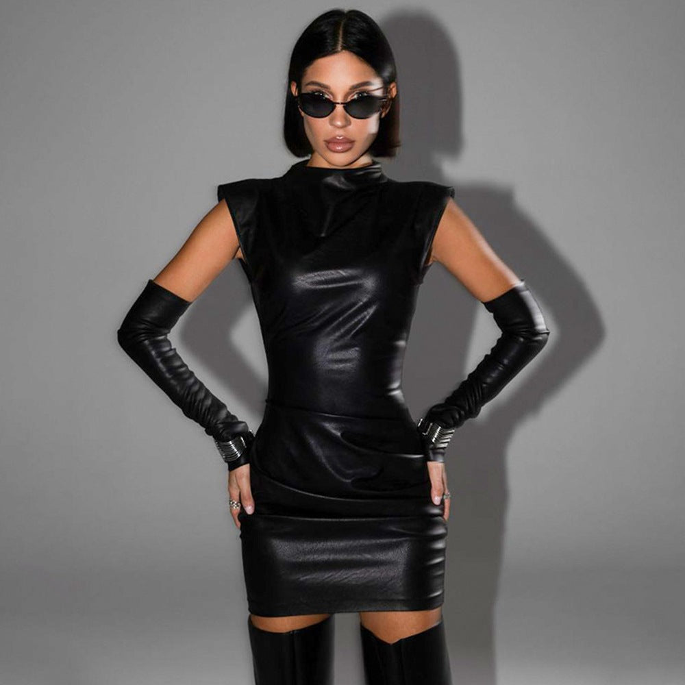 Woman in a black leather bodycon dress with attached gloves and sunglasses.