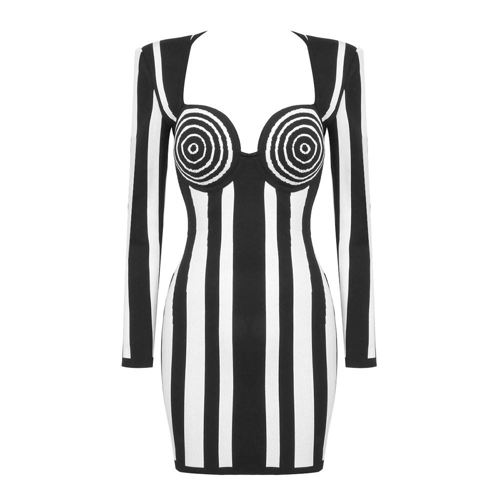 A black and white striped bodycon mini dress with long sleeves and a sweetheart neckline, laid flat.