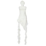 A white strapless dress with ruffled detailing and a flower embellishment is shown on a white background.
