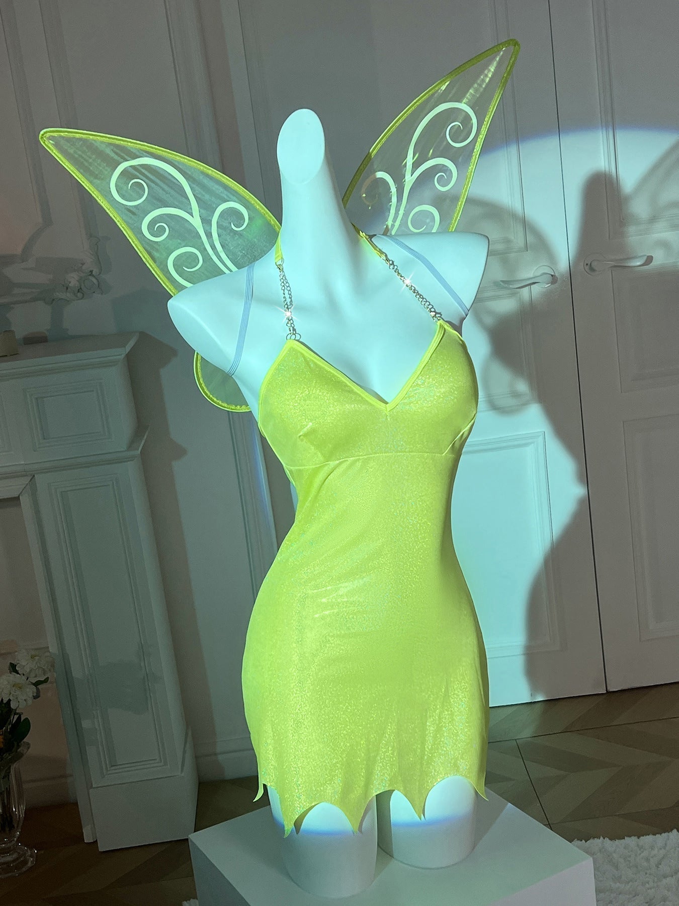 Mannequin displaying a sparkly green fairy costume with wings