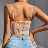 Back view of a woman wearing a tie-dye corset top with a smocked back and spaghetti straps.